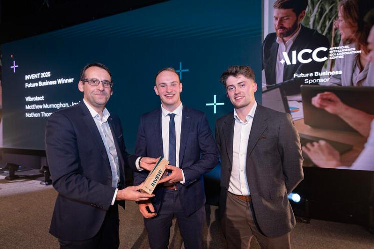 Two men are presented with an award