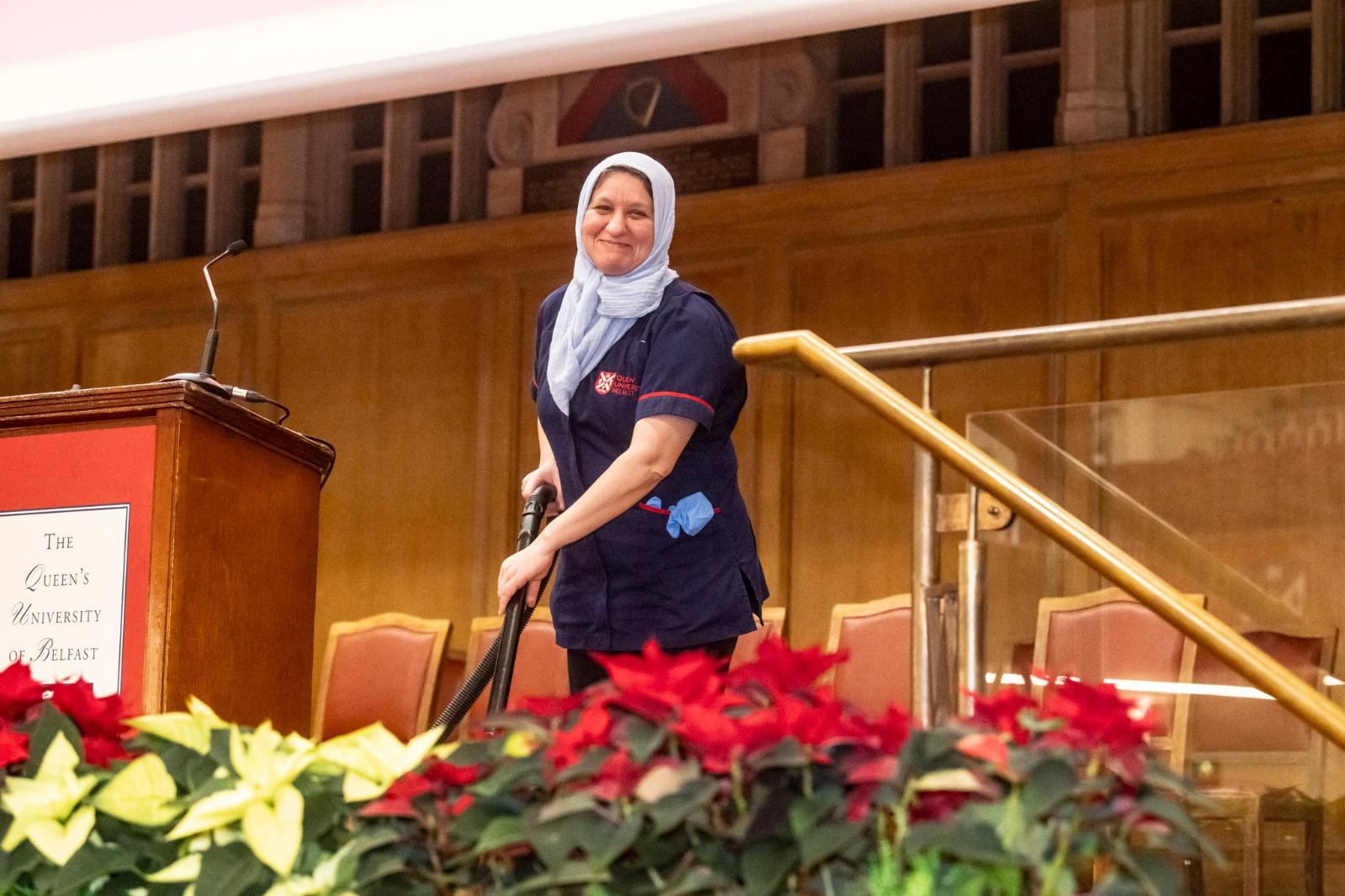 A Queen's University Belfast cleaner working behind the scenes, ensuring the campus is clean and well-maintained.