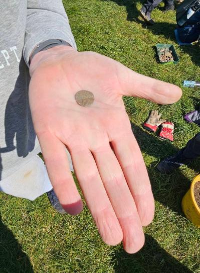 Hand holding a coin