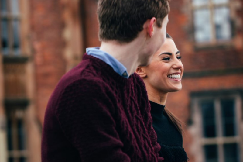 two graduates standing outside Queen's University