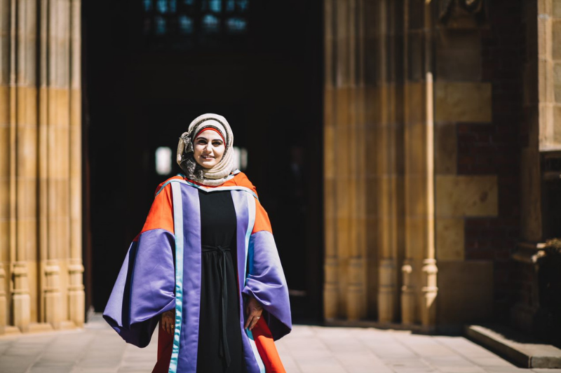 female student standing outside Queen's University