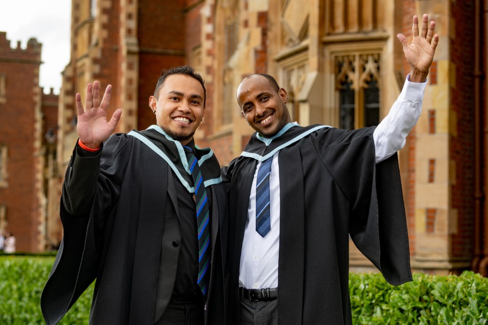 two male International students celebrating outside the Lanyon Building