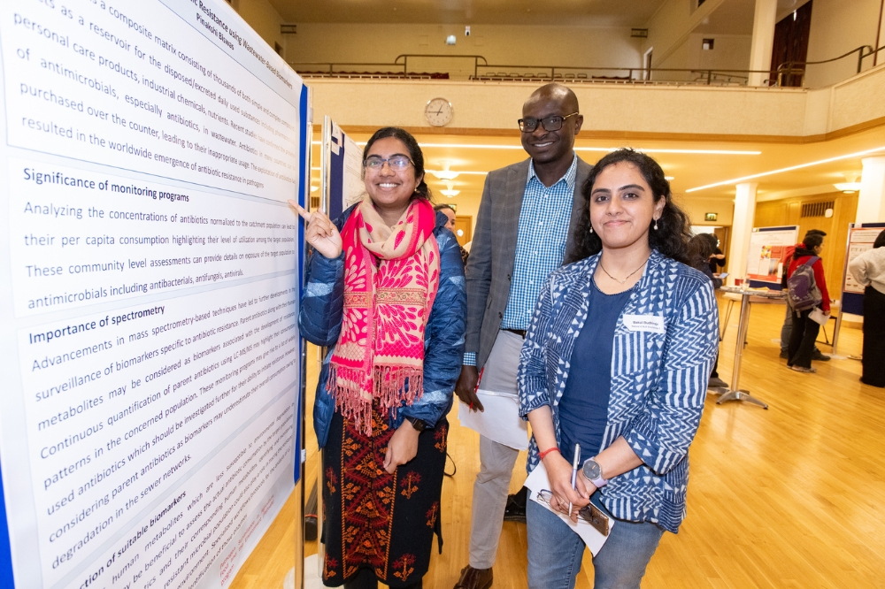 three smiling postdocs at the poster presentation at Queen's Postdoc Showcase 2023