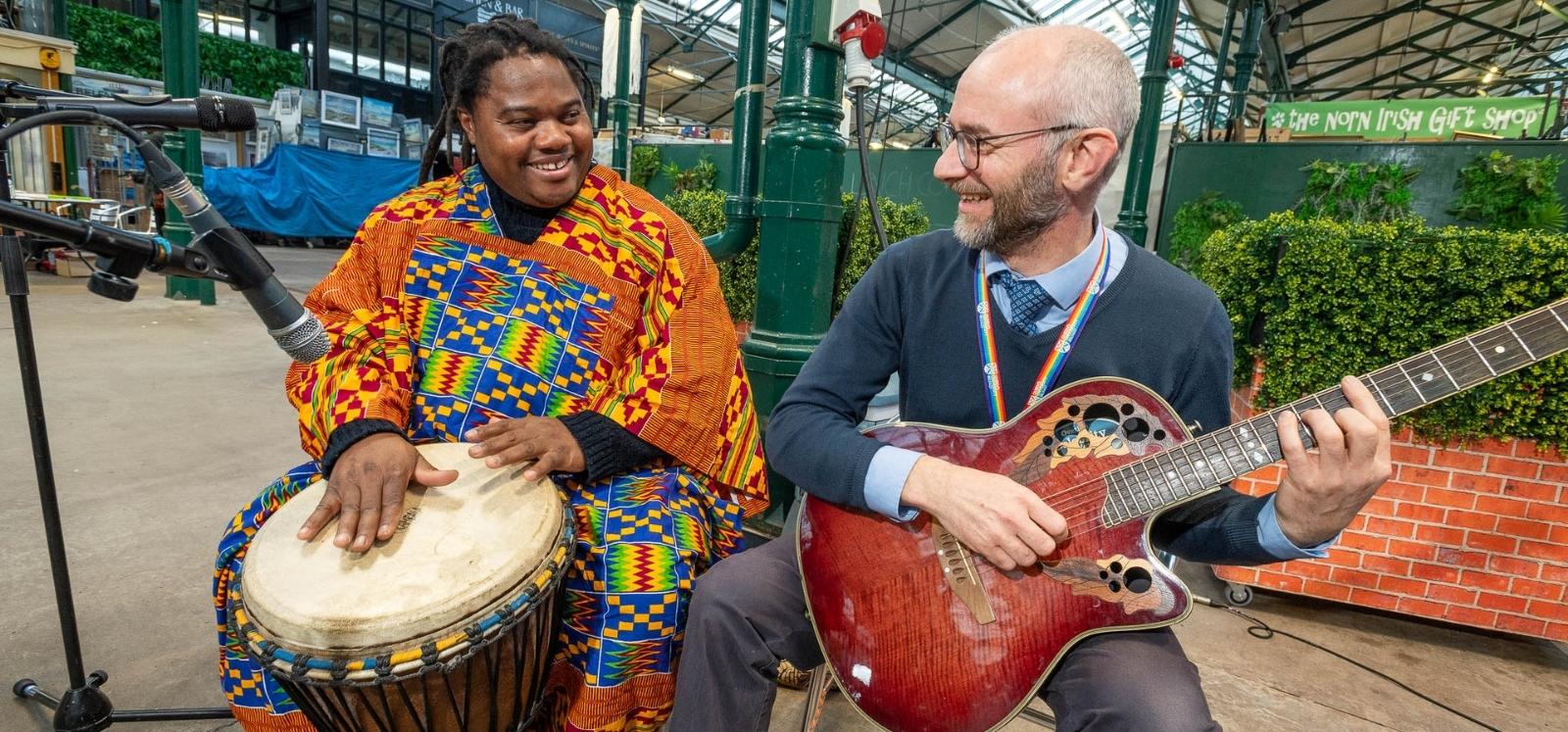 musicians playing djembe and guitar at the Black History Month expo, St George's Market