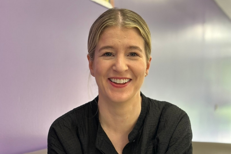 head and shoulders shot of Dr Clare Mulholland smiling to camera