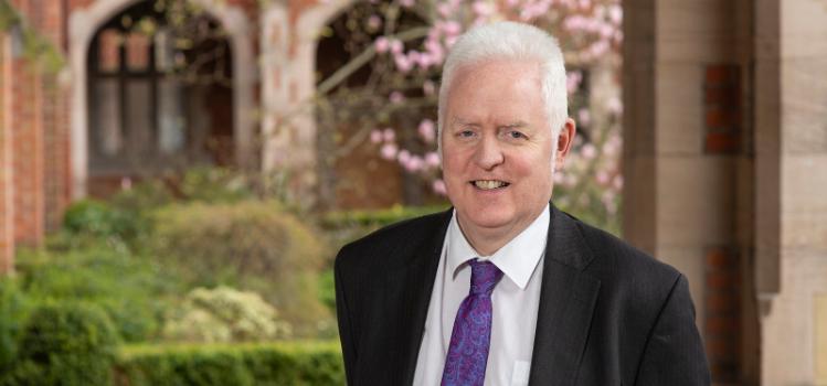 Professor Mark Lawler standing under the clock tower in Queen's quadrangle, March 2019