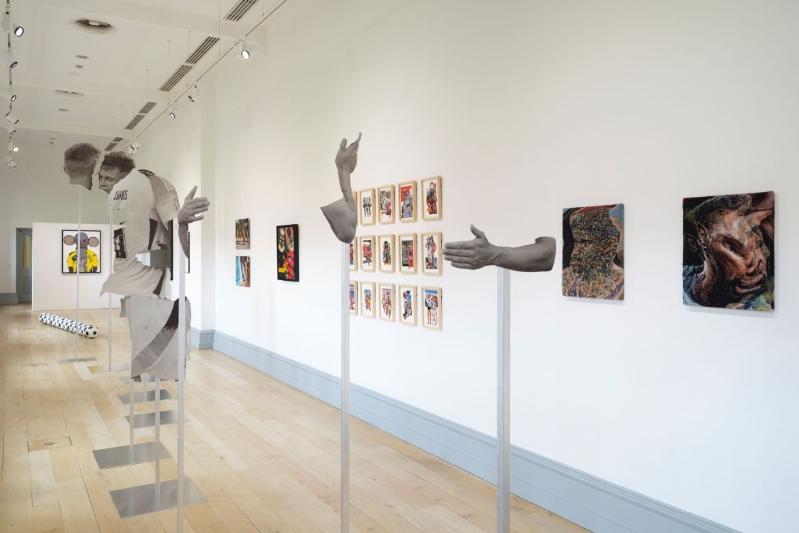 bright, white-walled art gallery displaying various abstract art axhibits