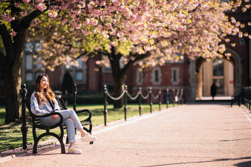 Student sitting in the Quad in Spring