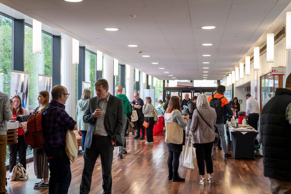 groups of attendees chatting in a foyer area at the Technician Showcase 2024